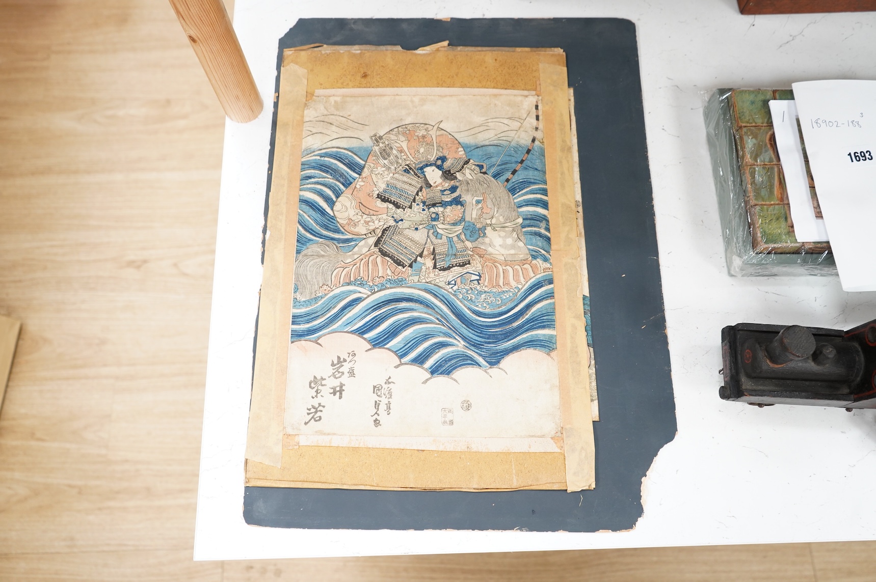 A collection of Japanese woodblock prints comprising Utagawa Kuniyoshi (1797-1861), After Utagawa Kuniyoshi, ‘Benkei on the Boat’ and another depicting a Samurai warrior on horseback, mounted, unframed, largest 35 x 24cm